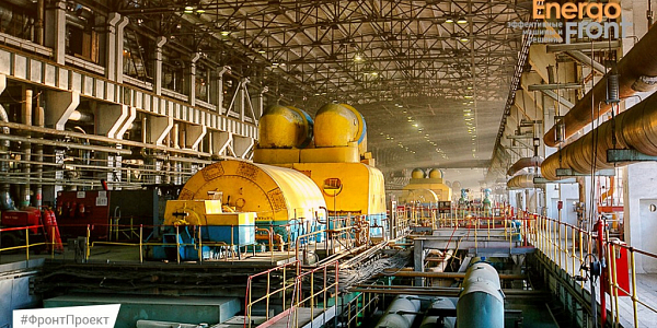 Machine room with a row of yellow-blue large units under the crane (Vladivostok CHPP-2)