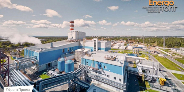 Aerial view of a modern plant with blue buildings, pipe and tanks