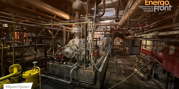 Workshop with a large pumping unit among a dense network of pipelines