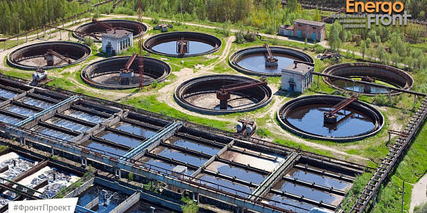 Aerial photograph of treatment facilities with round settling tanks and aeration tanks