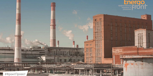 Industrial complex with red and white pipes and brick building