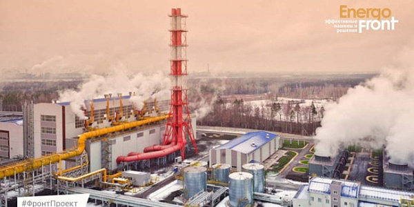 Aerial photograph of a plant with yellow pipelines, pipe and steam plumes
