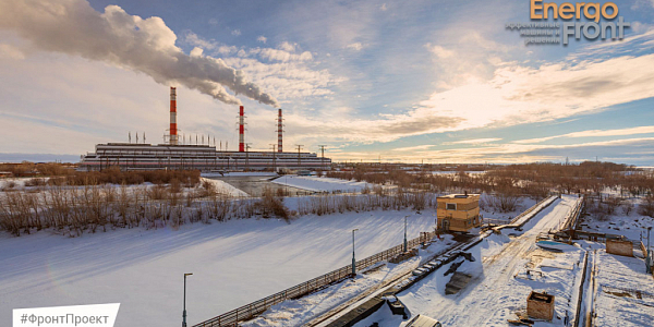 Winter view of a power plant with three red and white chimneys above the snow (Iriklinskaya GRES)
