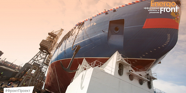 The bow of the nuclear icebreaker SIBERIA on the shipyard slipway with a coat of arms and an anchor