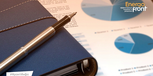 Blue notepad and fountain pen on a document background with pie charts