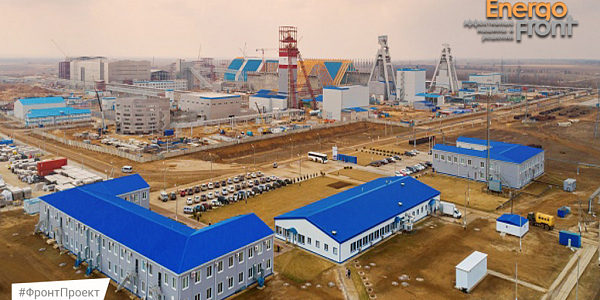 Aerial photo of a mining complex with modular buildings and headframes