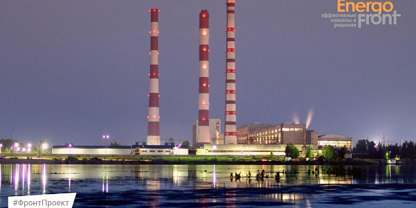 Night view of a power plant with three pipes and reflection in the water
