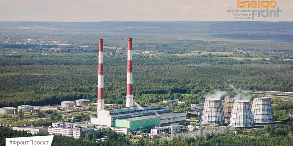 Aerial photo of a thermal plant with two chimneys and four cooling towers in the forest