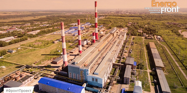Aerial photograph of an industrial area with four striped pipes, housings and a substation