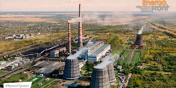Aerial photograph of a thermal power plant with cooling towers and chimneys, EnergoFront logo