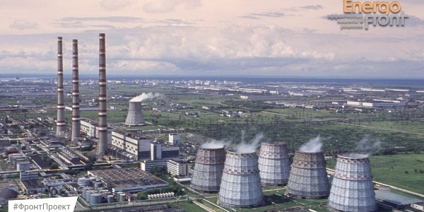 Panorama of a thermal power plant with cooling towers, red and white pipes and the city skyline (Samara Thermal Power Plant)