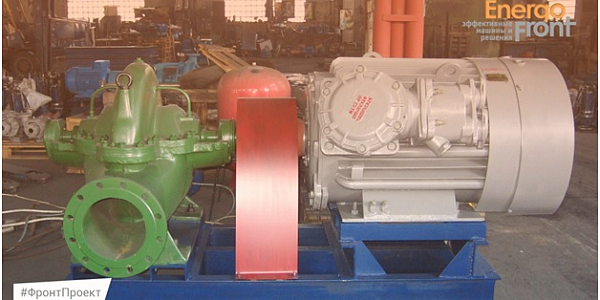 Pumping unit with green pump and gray electric motor on frame