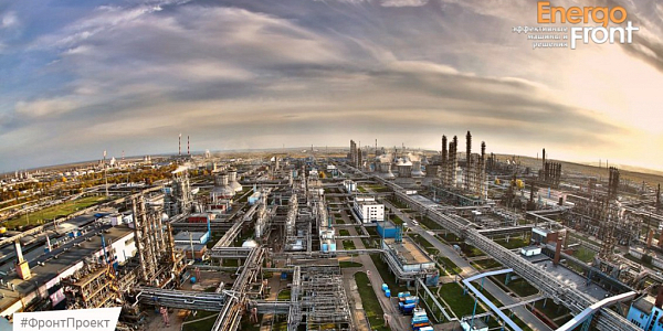 Panorama of a petrochemical plant with columns and pipelines under a cloudy sky