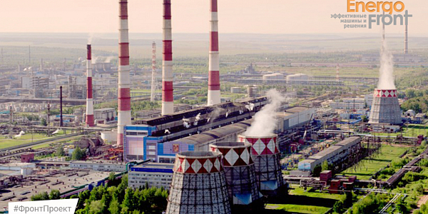 Panorama of a thermal power plant with checkered cooling towers and three red and white chimneys (Nizhnekamsk thermal power plant)