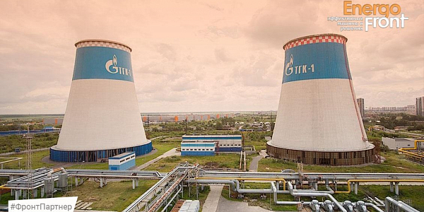 Two white TGK-1 cooling towers with logo and pipelines in the foreground