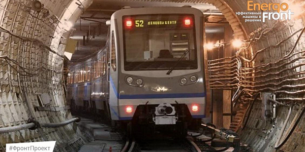 Subway train with BUSINESS CENTER display in a round tunnel with cables